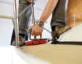 5 Lay the deck segment in place and align it precisely. To prevent bubbles from forming in the sun, it is important to avoid air pockets between the PVC and the deck. For this reason, the decking is carefully rolled on with a floor roller and pressed into place