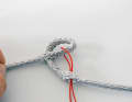 ... then thread a thin pilot line and use it to pull the eye through the opening. This twists the short part, ...