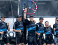 Peter Burling, co-CEO and driver of the New Zealand SailGP team, holds up the trophy as the New Zealand SailGP team celebrates their victory at the Mubadala New York Sail Grand Prix in New York, USA, with champagne from Barons De Rothschild on board their F50 catamaran