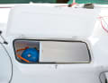 The dents in the cockpit are new. They allow the crew to brace to leeward and provide easily accessible storage space