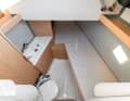 Separate: As an option, a small cabin can be installed in the foredeck for the skipper. Otherwise the space is used as sail load
