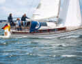 Wooden superstructure with classic windows, modern hull: a boat from two worlds