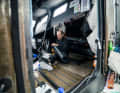 Below deck, Malizia navigator Nico Lunven is pushing ahead with the repair work