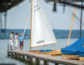 Anton Schwarz, shown here with customers, grew up by the lake and runs the business that his father built up in the 1960s