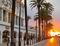 The sun bathes the promenade of Puerto de la Savina on Formentera in orange-red light