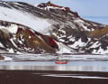 The bright red steel yacht in a secluded bay