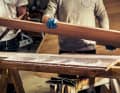 Les différentes couches sont enduites de résine époxy épaissie à l'aide d'une spatule dentée, puis le tout est pressé à l'aide de serre-joints.