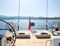 The aft deck becomes a relaxation zone. The dinghy is parked alongside underneath.