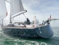 The stern is closed. A dinghy is lifted with davits
