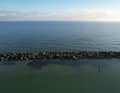 The stones of the breakwater have partly sunk or been washed down