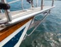 The anchor protrudes through an opening in the bow, so the deck is free of chain and winch