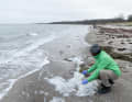 In Kühlungsborn, Dr Julios Kontchou, Greenpeace, takes a sample of the sea foam to analyse it for PFAS.