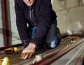 The author inspecting a classically laid teak rod deck. Baykowski is in demand as an expert for wooden boat building