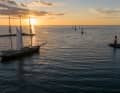 A traditional sailing ship in the setting sun