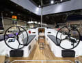 The double steering wheels are free-standing. This opens up the side passages to the laterally recessed running deck