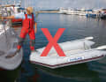 Wrong: the step over the bow ON the hose of the dinghy
