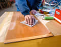 Sanding: The wood is in good condition and sealed with a hard clear varnish. To ensure that the white lacquer adheres well, the surface is roughened with sanding fleece until it is evenly matt