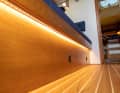 The LED strips are glued under the overhang of the saloon bays with the help of the profile strips, they shine vertically downwards onto the floorboards, which results in very nice indirect lighting, the brightness can be adjusted downwards for night sailing