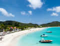A real dream beach plus boats bobbing in front of it.