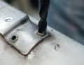 The head can be removed using the drill bit, which should be slightly larger than the rivet hole