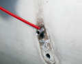 The rivet can now be hammered through.  If it is tight, a little penetrating oil will help ...