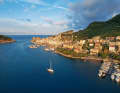 A magical atmosphere over Porto Venere. The mild light of the evening sun illuminates the houses in the old town centre