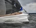 Open fire. At over 16 knots, the spray rails on the bow do a great job, most of the spray drifts to the side