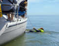 Whether mooring line or sheet, the main thing is to establish a line connection to the casualty immediately. Then think about how to get him on deck