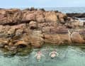 The crew uses the delay in clearing out for shore leave; swimming ...