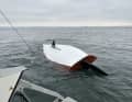 The capsized 15 dinghy cruiser, the mast stuck in the bottom