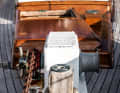 Compromise: The high box-shaped superstructure with the Dorade fans and the handrails is due to the shallow freeboard