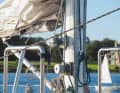 The halyard winches are mounted on the mast, where the crew is held by brackets