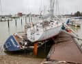After the storm surge: The yachts piled up on the jetties in Damp.