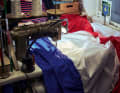 Small and large national flags: Katja Fromm sews different coloured fabrics into a flag in several steps in the workshop