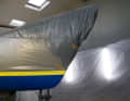 Before blasting, the surface vessel is packed dust-tight, and robust adhesive tape protects the gelcoat at the water pass
