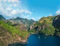 Two blue water sailors at anchor in the Bay of Virgins on the west coast of Fatu Hiva.  In the narrow valley between the rocks lies the village of Hanavave