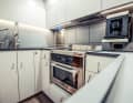 Galley: Here, just a few steps below the saloon, the owner also likes to cook for himself. The door to the crew quarters aft can be closed for more privacy