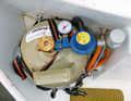 The well-ventilated cabinet contains the cylinder with pressure gauge for testing pressure loss and the remote control valve (right)