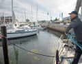 Use both hands to swing the bays backwards past the sides of the body, staying clear of the sea fence