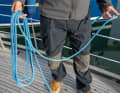 Secure the fixed part on the cleat, take the loose part in your hand or also secure it on board. Drop some loose line on board. Then shoot the line up a few bays in your casting hand