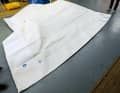 Starting from the taut lower leech, furl the genoa in bays. Think about battens and leech straps beforehand