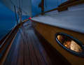 Sweet dreams. While a sailor steers the boat through the night, the free watch sleeps peacefully below deck