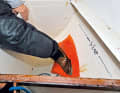A cushion and a foot are initially enough to dry up the spring. This is not a permanent solution. But it buys time to organise tools and materials to seal the leak in the best possible way and thus save the entire ship