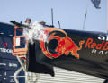 Taufpatin Chiara Bertarelli lässt die Champagnerflasche zur Taufe von Alinghi Red Bull Racings "BoatOne" bersten