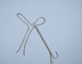 Guide the splicing needle into the halyard and allow it to exit at the intersection, pierce the short end, thread the rope and pull it into the halyard