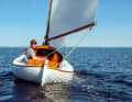 Satisfied all round. Florian Melzer at the tiller of his restored pointed gaff from 1946