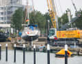 Damp: The crane manoeuvres in the tightest of spaces