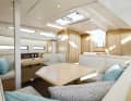 The interior offers a U-shaped sofa and a dinette opposite.