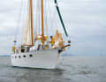 The owner built the schooner rig from wood to match the clipper bow. The high hull with the flat deckhouse looks indestructible and seaworthy