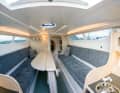 The saloon is divided by the centreboard box, the benches that can be converted into a bed offer plenty of space even for a large crew
